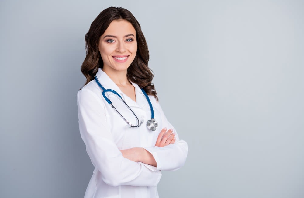 woman leaning against a wall in dim hallway